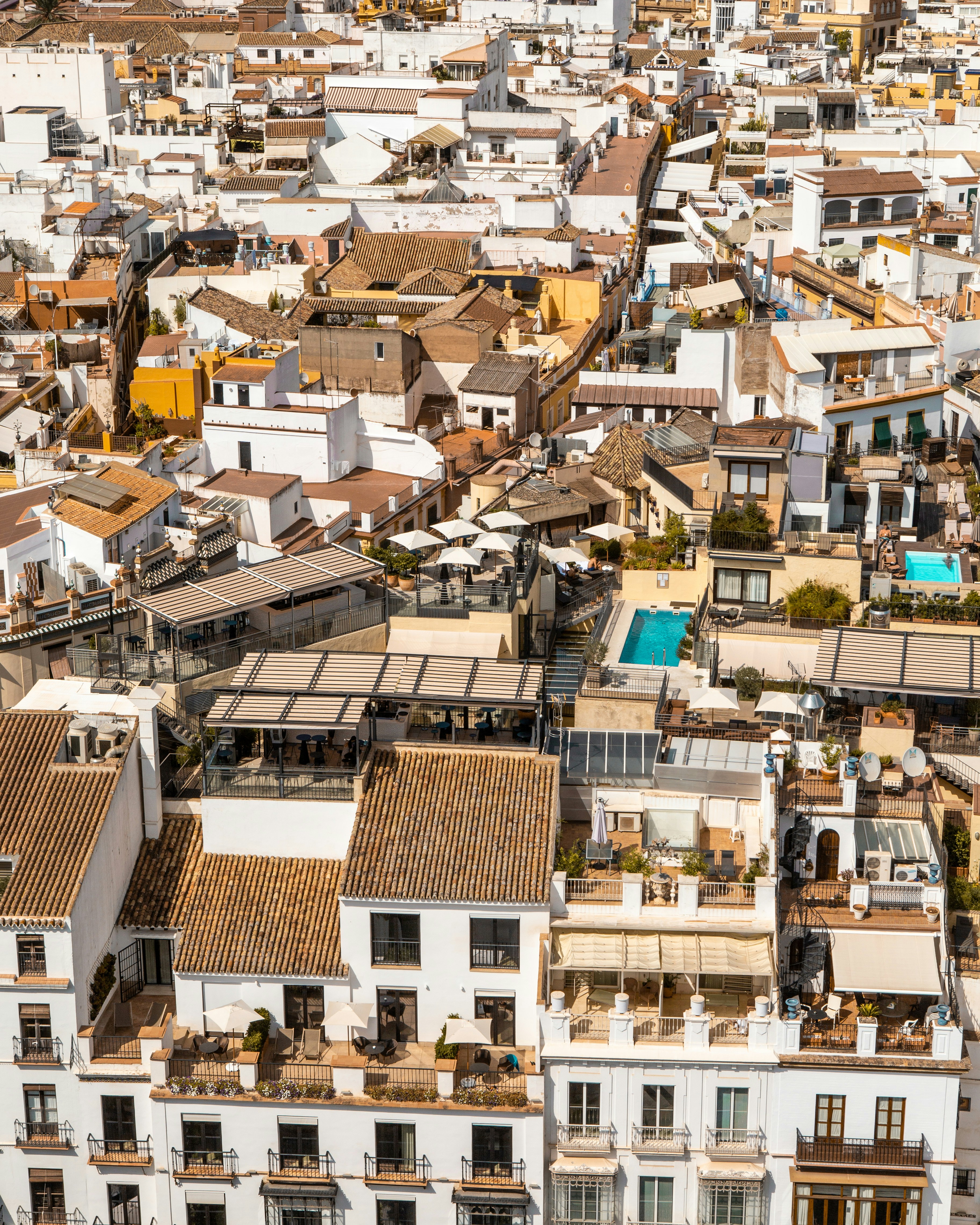 Aerial view of Spanish city with white buildings and terracotta rooftops